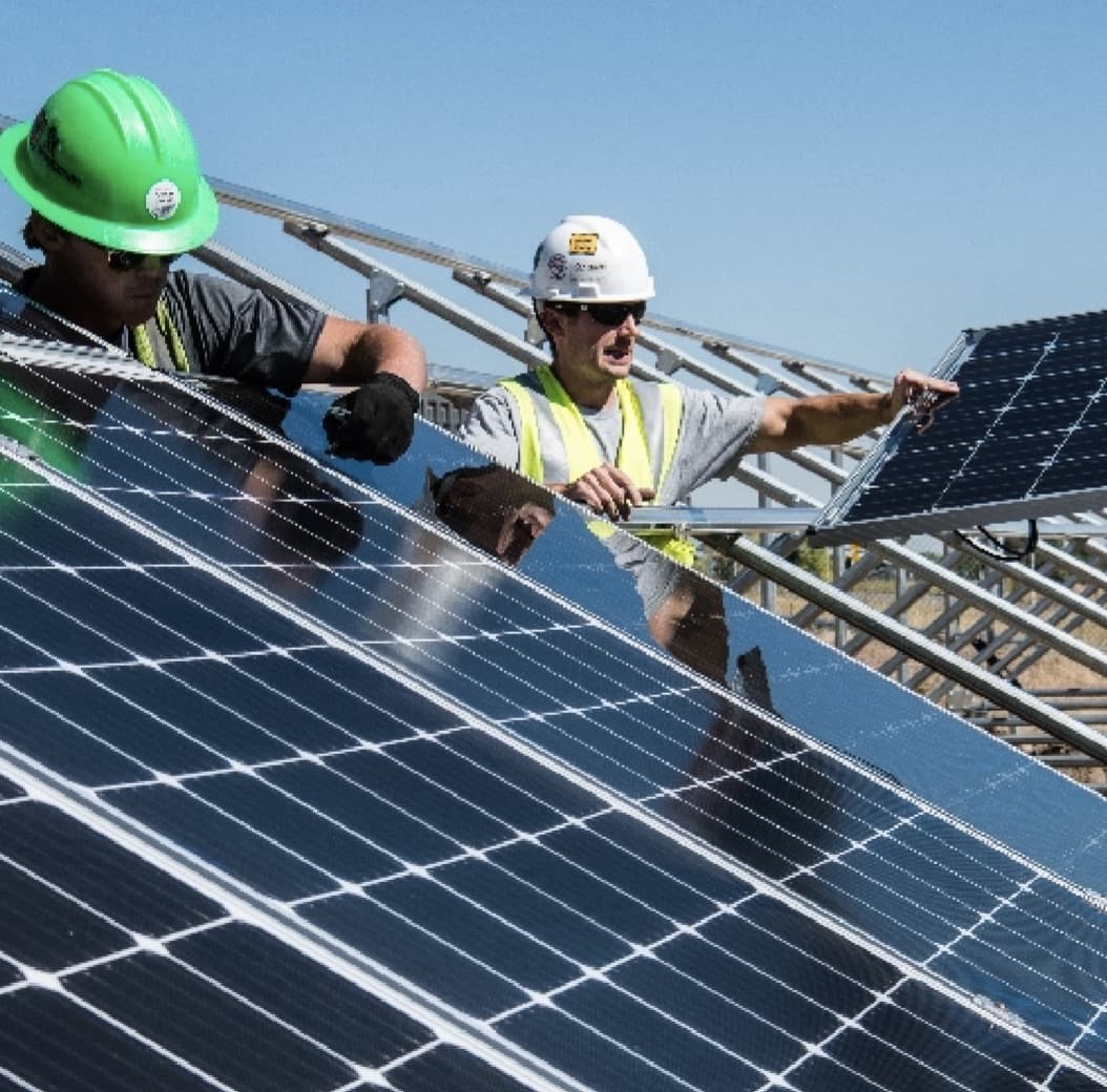 people working on solar panels